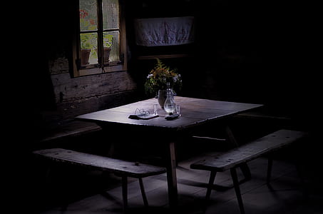 clear glass bottle on brown wooden table near window thumbnail