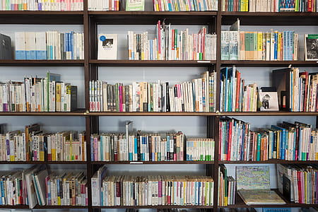 assorted book lot and brown wooden book shelf thumbnail