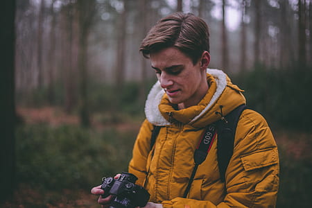 man holding DSLR camera on forest thumbnail