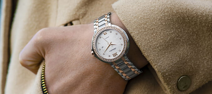 person wearing brown coat and silver-colored watch thumbnail