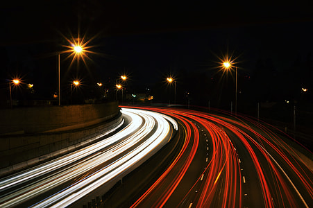 timelapse photography of speeding cars during night time thumbnail