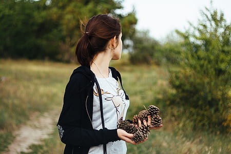 woman holding pine cones thumbnail