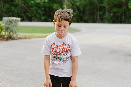 boy standing on concrete road thumbnail