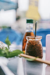 Selective Focus Photography of Clear Glass Jar With Brown Powder thumbnail