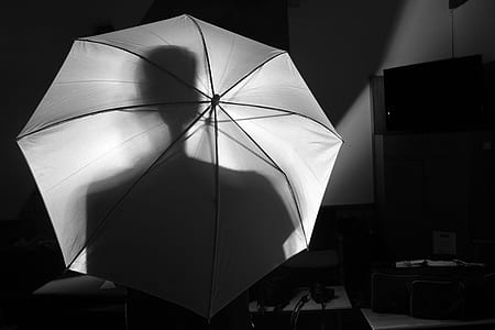 person holding white umbrella thumbnail