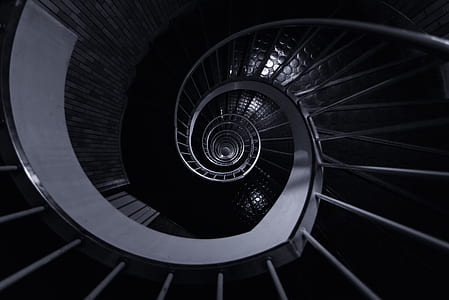 grayscale photo of spiral stairs thumbnail