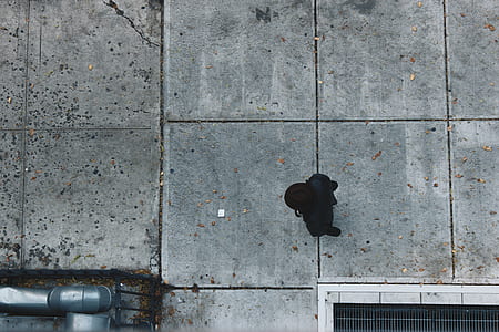 person walking on gray concrete walkway thumbnail