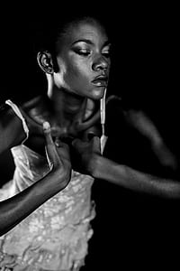 grayscale photography of woman with hands on chest thumbnail