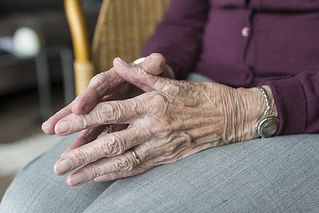 person sitting on chair doing praying hands gesture thumbnail