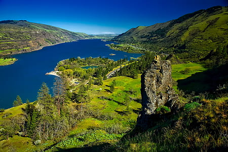 aerial photography of mountain range near body of water thumbnail