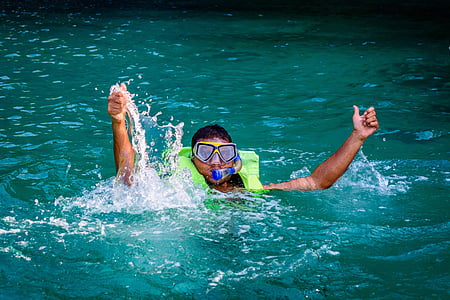 man wearing green snorkel in body of water thumbnail