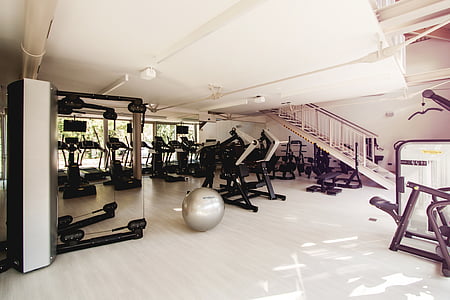 gray stability ball on white surface near gym equipments thumbnail