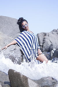 woman standing behind rocks thumbnail