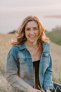 woman sitting on green grass field thumbnail