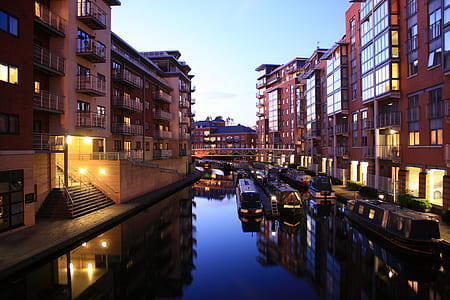 brown buildings near body of water thumbnail