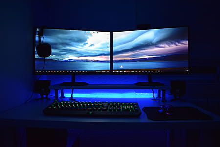 Two Computer Flat Screen Monitors Turned On thumbnail