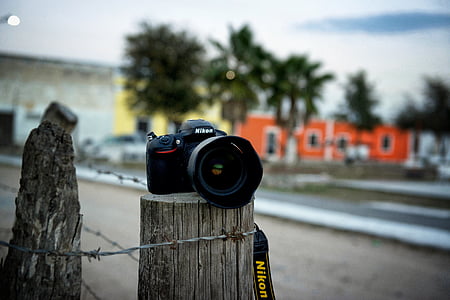 selective focus photo of black Nikon DSLR camera thumbnail