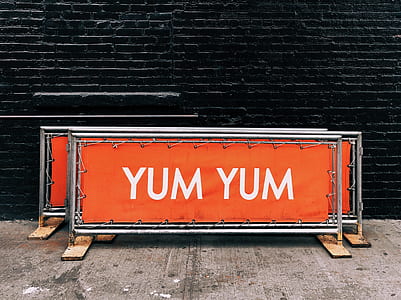 red and gray signage beside black wall thumbnail