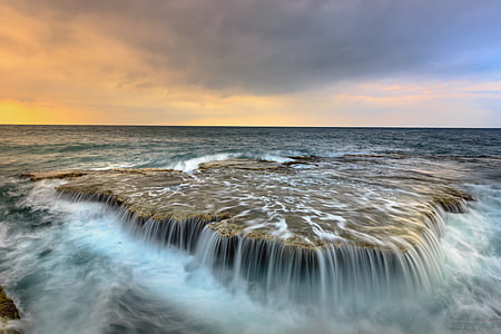 brown rock in ocean thumbnail