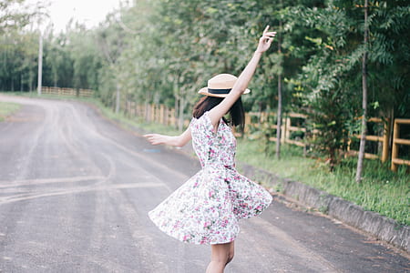 woman dancing on road surrounded by trees thumbnail