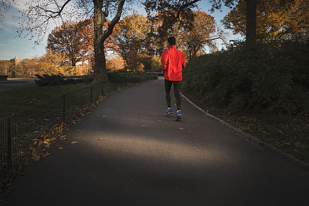 person jogging on gray concrete road during daytime thumbnail