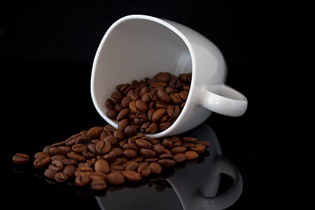 spilled coffee beans on black surface thumbnail