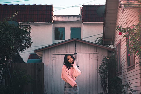 woman wearing orange sweatshirt and gray skirt thumbnail