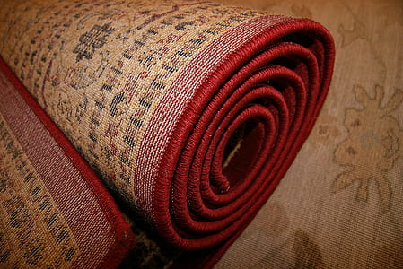 rolled brown and red floral rug thumbnail