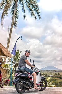 Man Riding Motor Scooter thumbnail