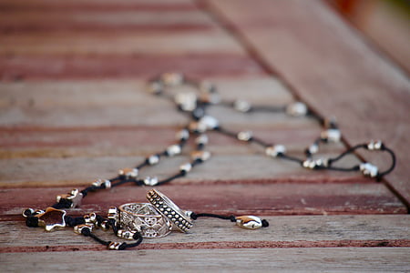 close-up photo of silver-colored and black necklace thumbnail