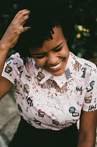 woman wearing white polo shirt and black bottoms while holding her head thumbnail