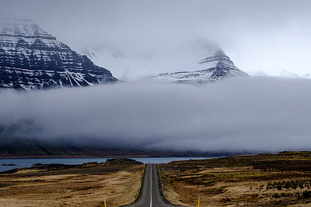 snow-capped mountain surrounded with fog thumbnail