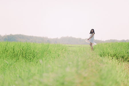 Woman in White Dress on Green Grass Field thumbnail