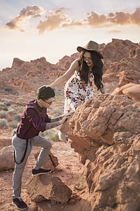 man and woman climbing rock thumbnail