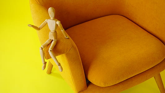 brown wood puppet on armrest thumbnail