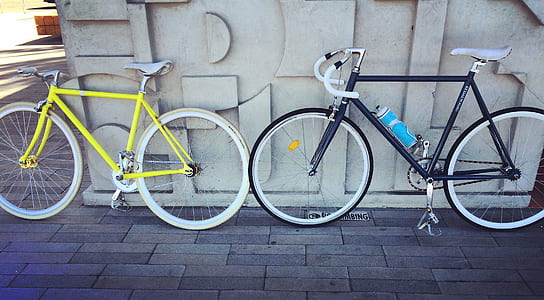 two yellow and black road bikes thumbnail