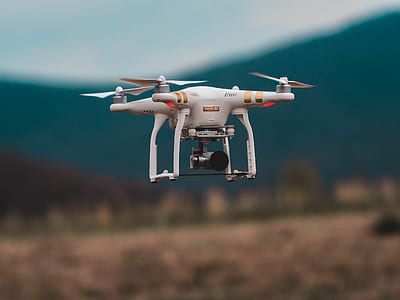 selective focus photography of white DJI Phantom 3 taking flight thumbnail