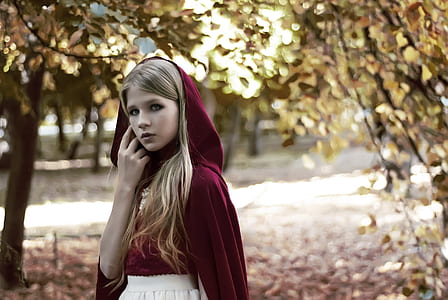 woman wearing red hooded jacket during daytime thumbnail