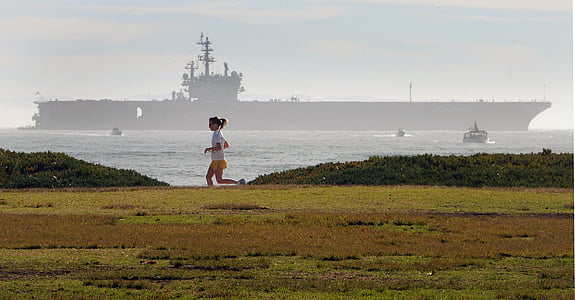 woman running beside blue sea thumbnail