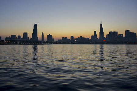 photo of cityscape and body of water during daytime thumbnail