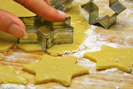 person holding gray star cookie cutter thumbnail