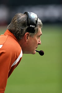 man in orange and white polo shirt wearing black and white AT&T headset thumbnail