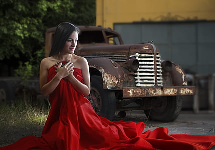 woman in red dress near brown utility truck thumbnail