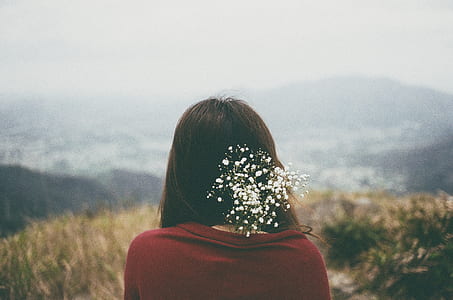 woman in red top facing brown plants thumbnail