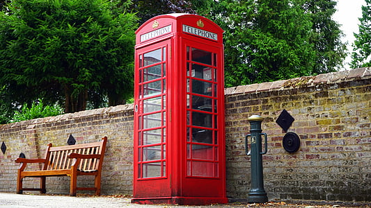 red payphone near brown wooden bench thumbnail