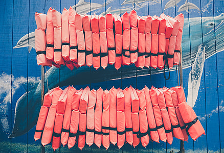 red life vest lot hanging on rack thumbnail