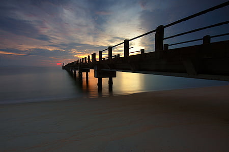 brown wooden dock under clear blue sky thumbnail