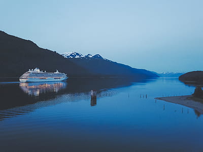 white cruise ship near mountain thumbnail
