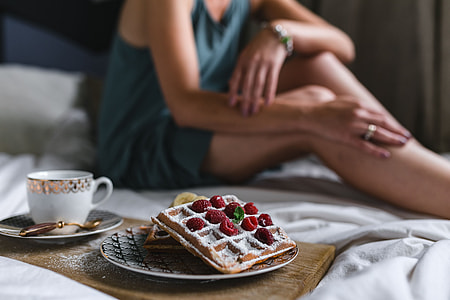 Breakfast in bed - waffles with raspberries and cup of coffee on the tray thumbnail