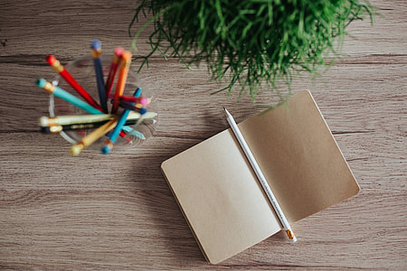 Notebooks with colourful pencils on a wooden desk | free photos ...